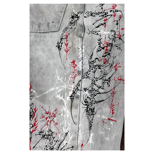 Gray denim jacket with black and red abstract designs on a white background