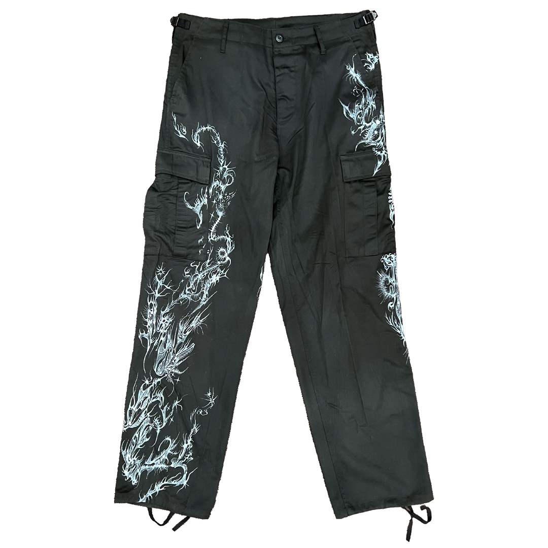 Black cargo pants with white dragon designs on a white background