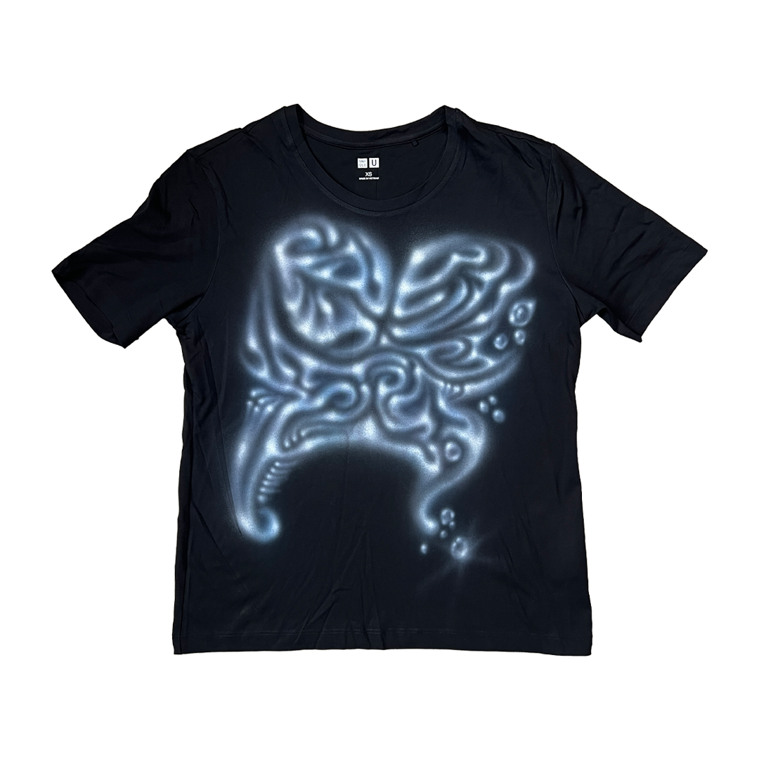 Black t-shirt with a glowing alien head design on a white background